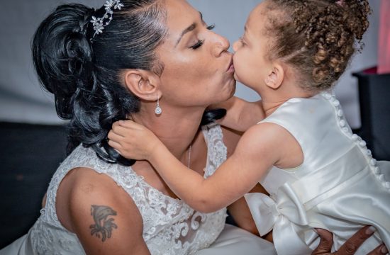 Bride kissing daughter