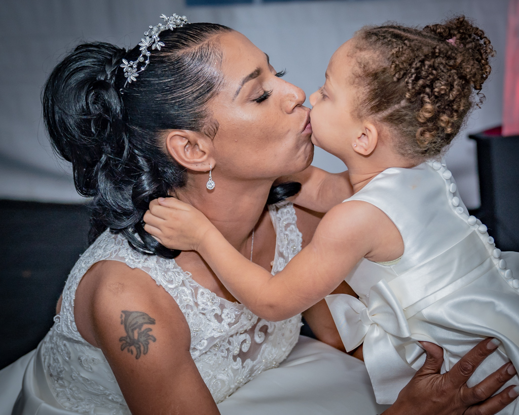 Bride kissing daughter