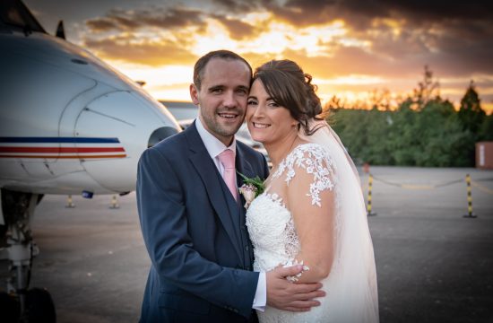 Bride and Groom in front of plane