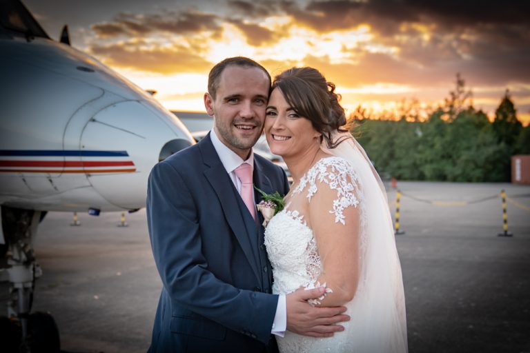 Bride and Groom in front of plane
