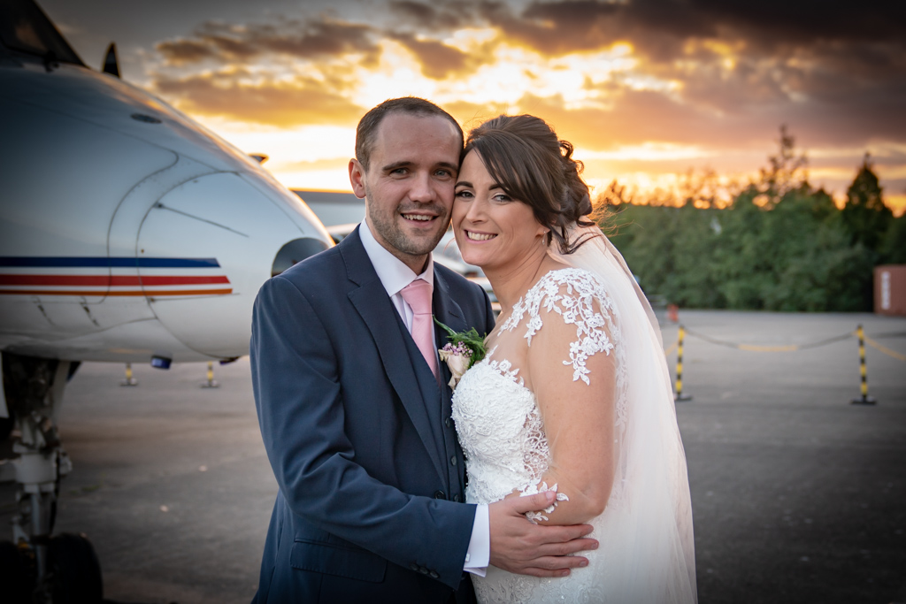 Bride and Groom in front of plane